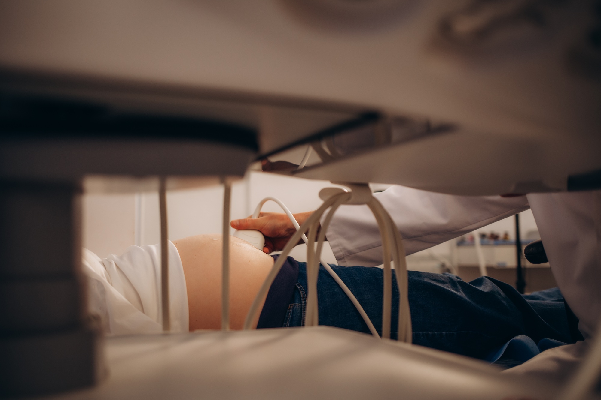 Ultrasound examination of the fetus. Pregnant woman in gynecological surgery. Gynecologist.
